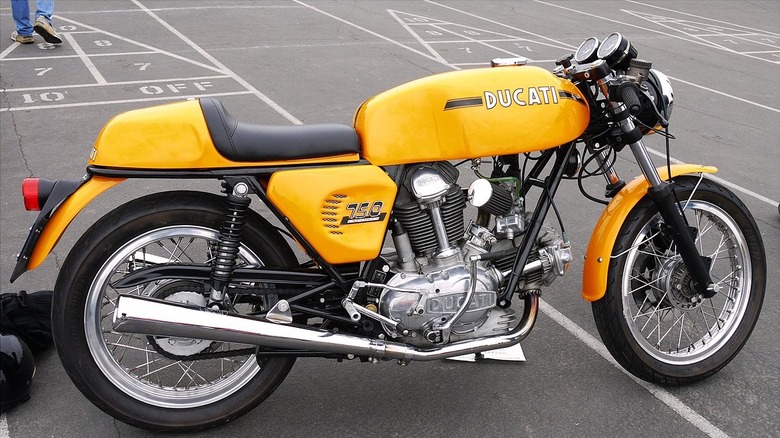 A yellow Ducati 750 GT standing in Joels collection at Oyster Bay