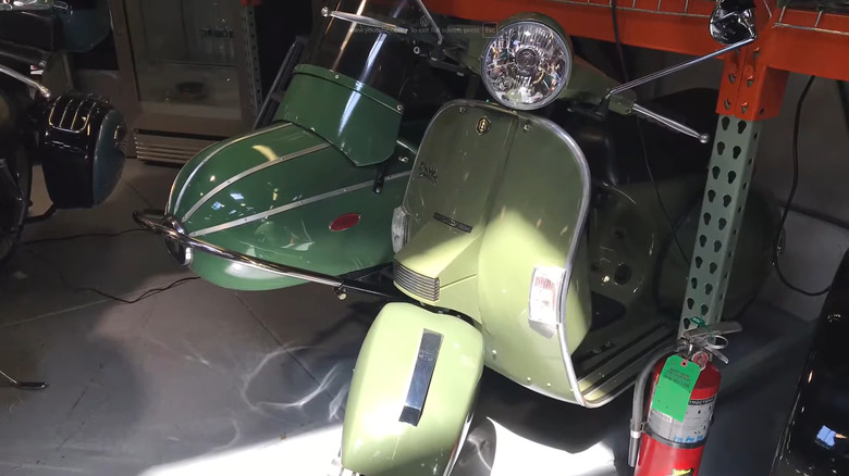 A green GSC Stella with sidecar parked in a corner at 20th century cycles