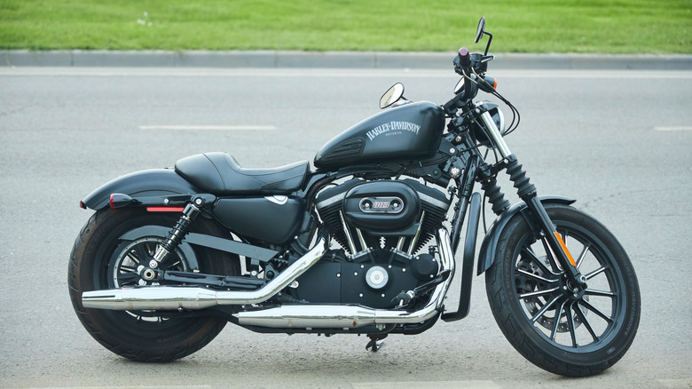 A Harley Davidson Sportster Forty Eight parked on a road