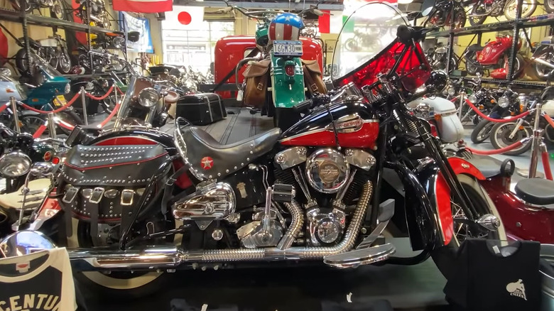 A black and red Springer Knucklhead parked next to a 2008 Harley