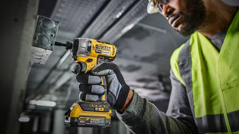 Worker using DeWalt impact driver