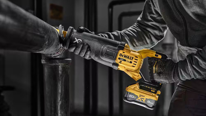 DeWalt reciprocating saw cutting through a pipe