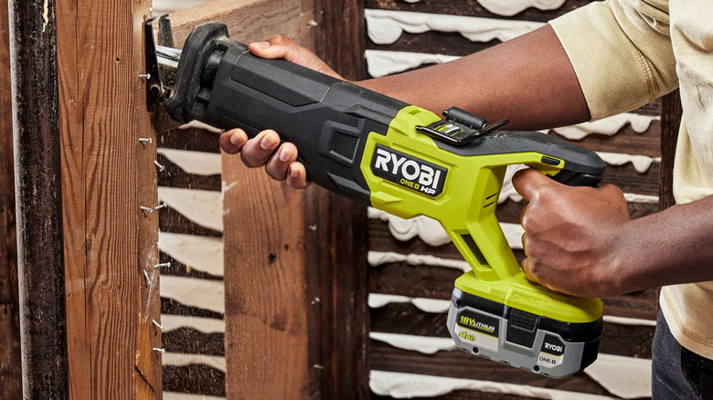 DIYer using a Ryobi Reciprocating Saw