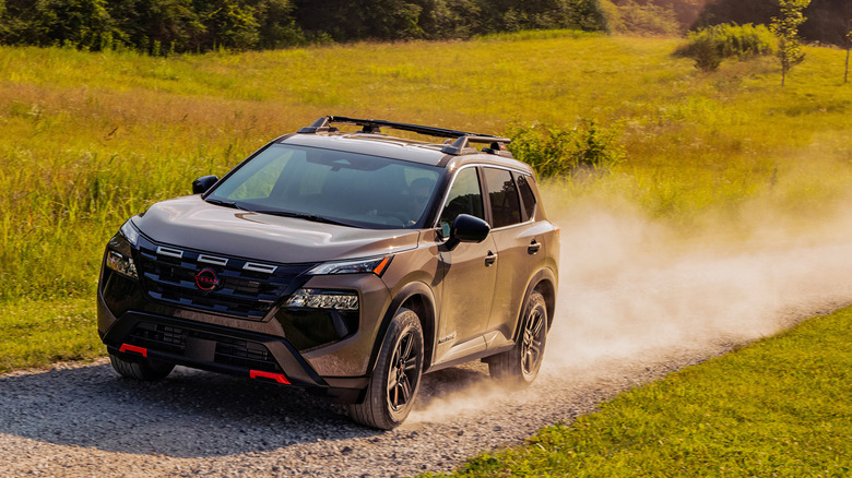 2025 Nissan Rogue Rock Creek Edition dynamic image on the trail front 3/4 view