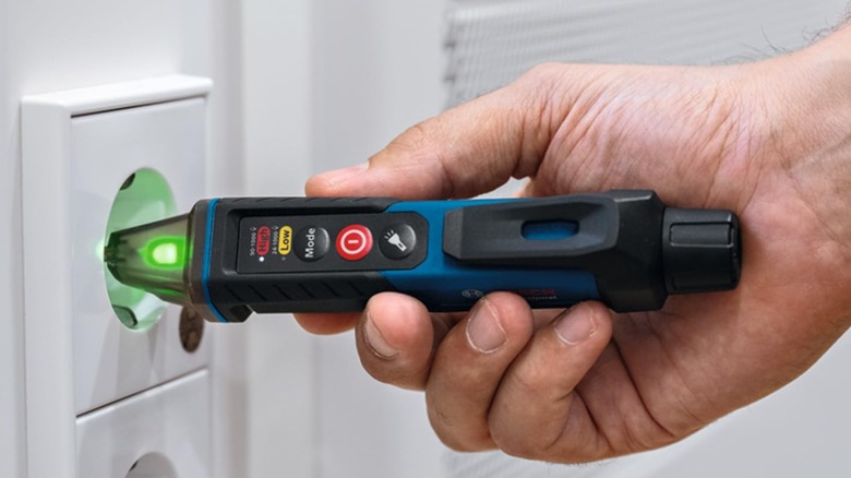 testing outlet with voltage tester