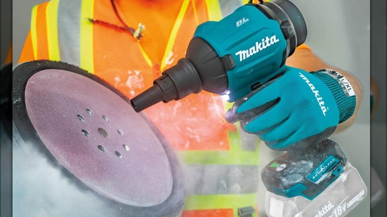 cleaning sanding disc with Makita blower