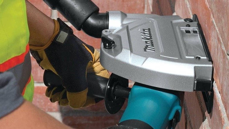 person using a Makita grinding mortar with tuck point grinder