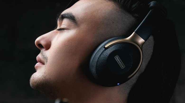 Man listening to Positive Grid headphones