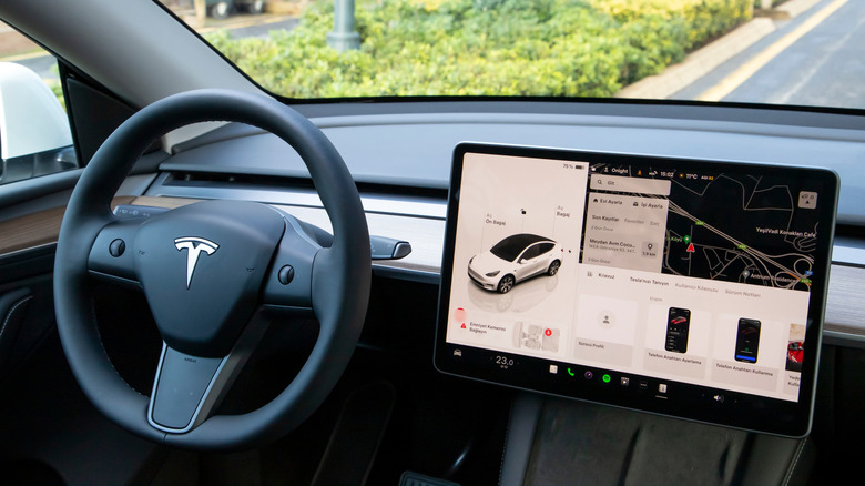 A passenger-side view of the massive infotainment display inside a Tesla
