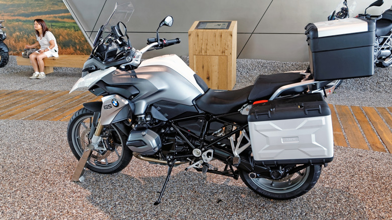 A white BMW F800 R which borrowed heavily from the Lo Rider outside a BMW showroom.