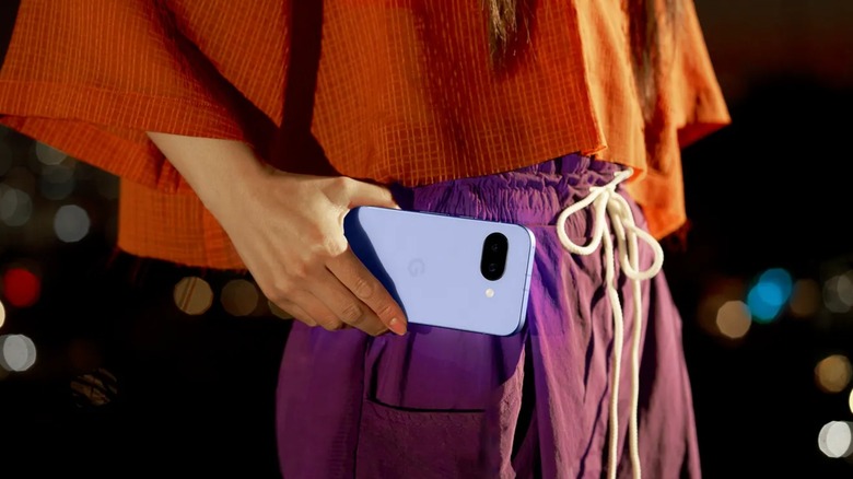 A person holding a Google Pixel 9a near their hip