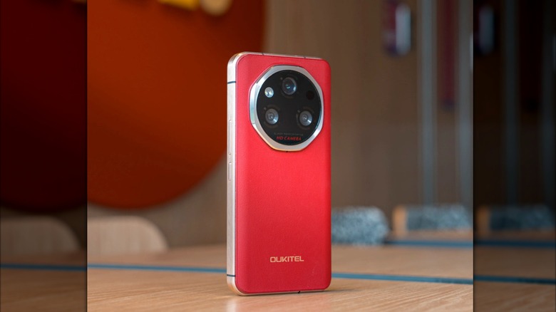 A red Oukitel WP210 standing up on a table