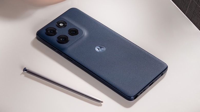 A Moto G Stylus phone lying face-down on a table with its stylus out