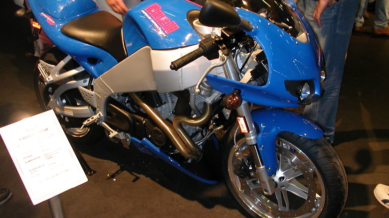A blue and silver Buell XB9R Firebolt sitting in the middle of a museum
