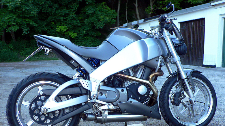 Silver Buell XB9S Lightning motorcycle in an empty parking lot with a white house in the background