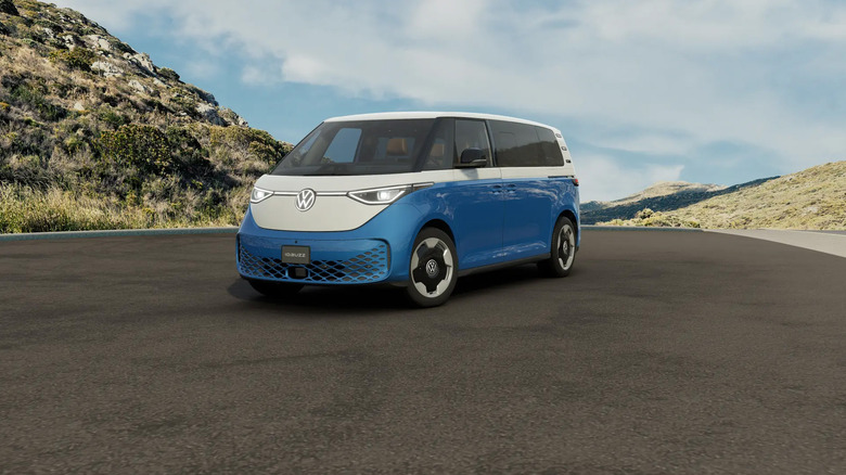 A blue and white Volkswagen ID.Buzz sitting on a hillside road.