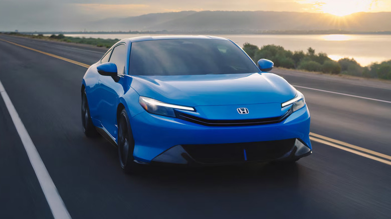 A blue Honda Prelude driving on a freeway