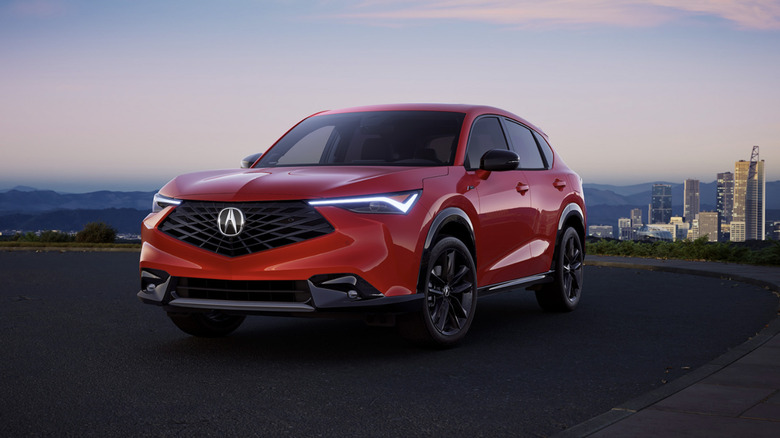 A red Acura ADX against a cityscape