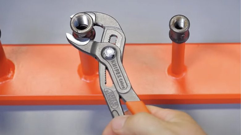 slip joint pliers on a piece of metal