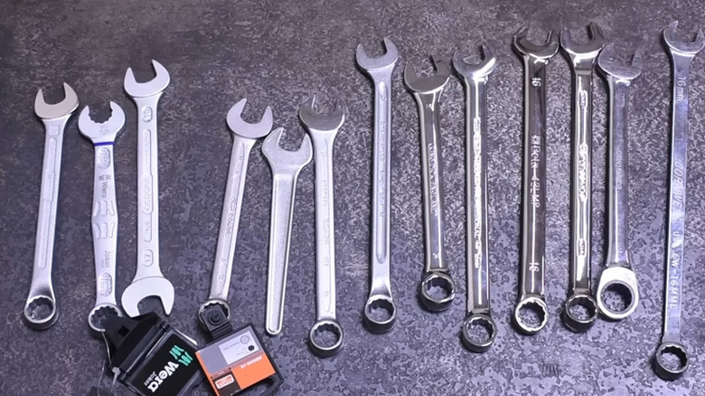 a table full of open ended wrenches from different brands