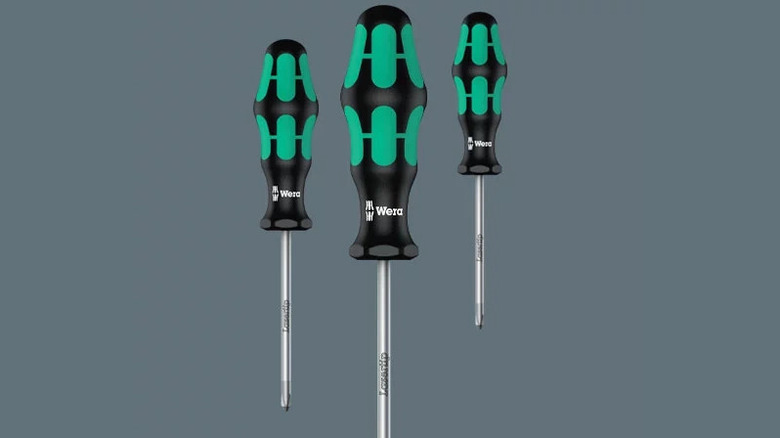 Three screwdrivers with black and green handles