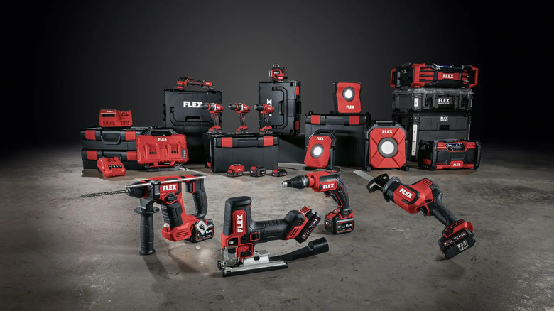 Full lineup of FLEX 24V power tools and accessories arranged on a concrete floor.
