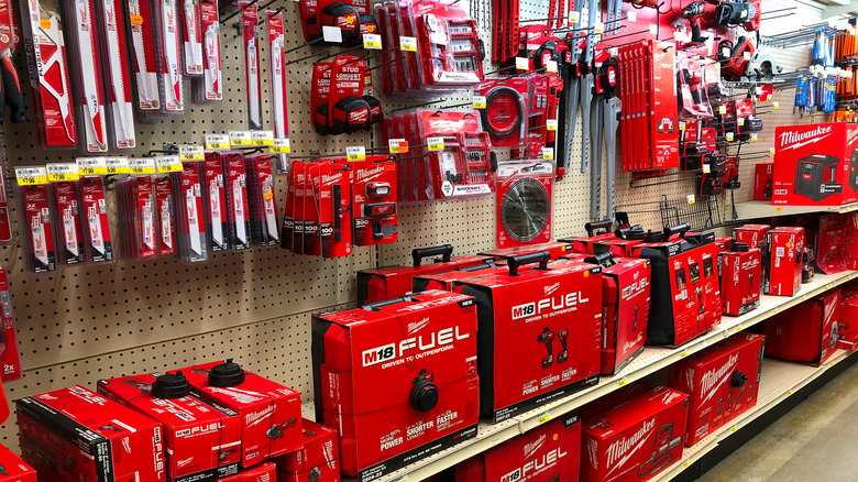 A store shelf stocked with Milwaukee tools and accessories.