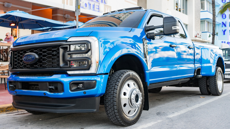 Blue Ford super duty parked on a street