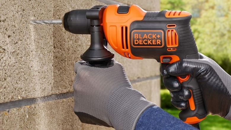Person using Black+Decker hammer drill