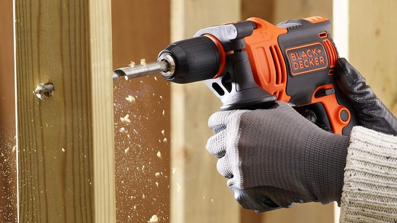 Hammer drill drilling wooden stud