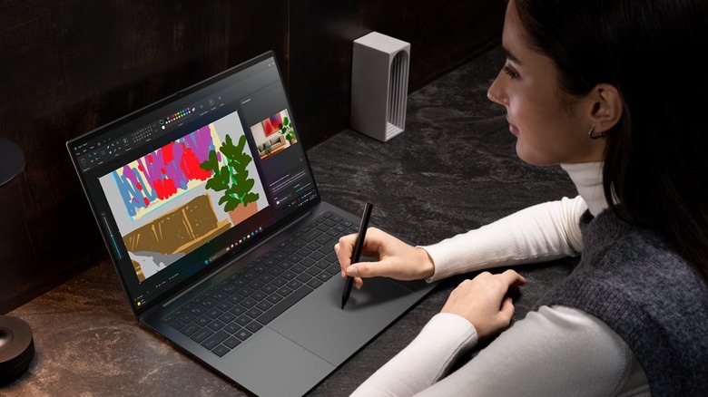 woman using stylus on open Acer Aspire 16 IA laptop