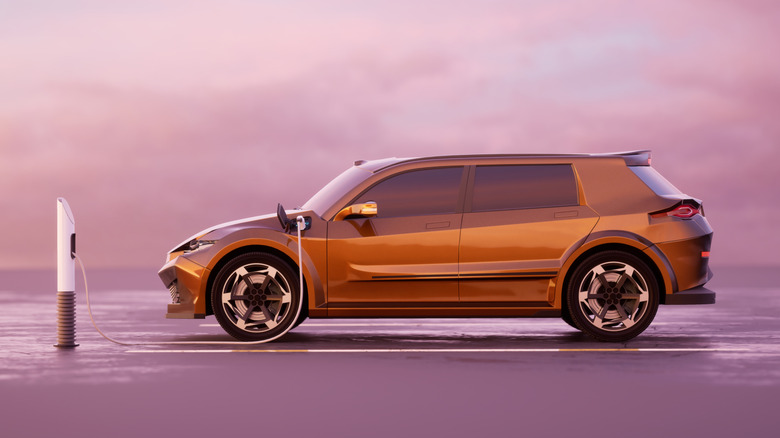 An orange electric SUV in charge