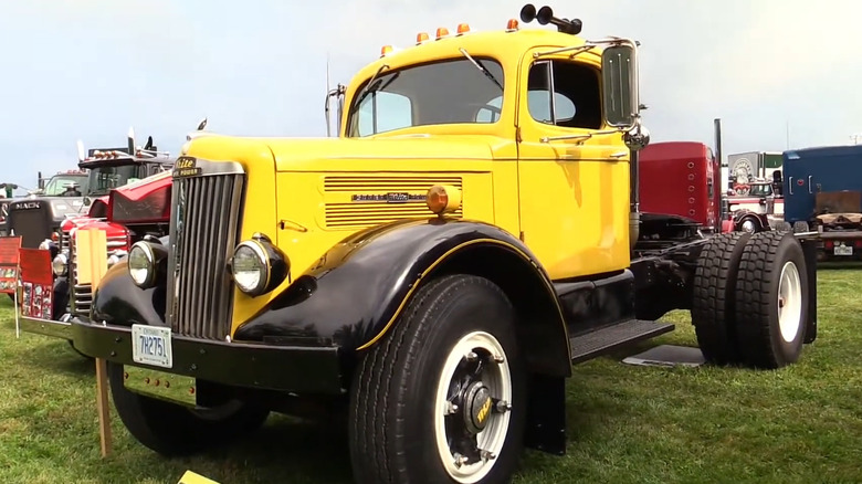 A white WC20, very similar to the WC22, parked at a truck show on an overcast day