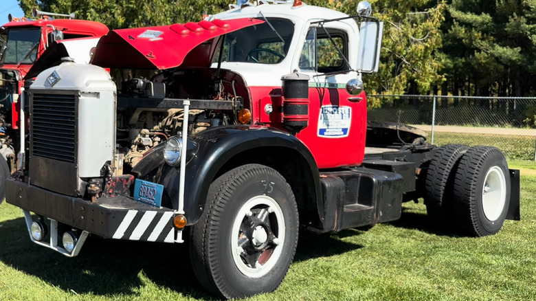 A red and white restored Diamond T 922/923 semi truck at a truck show