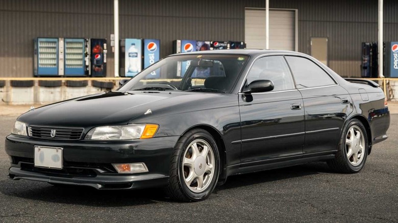 Toyota Mark II JZX90 with a warehouse in the background