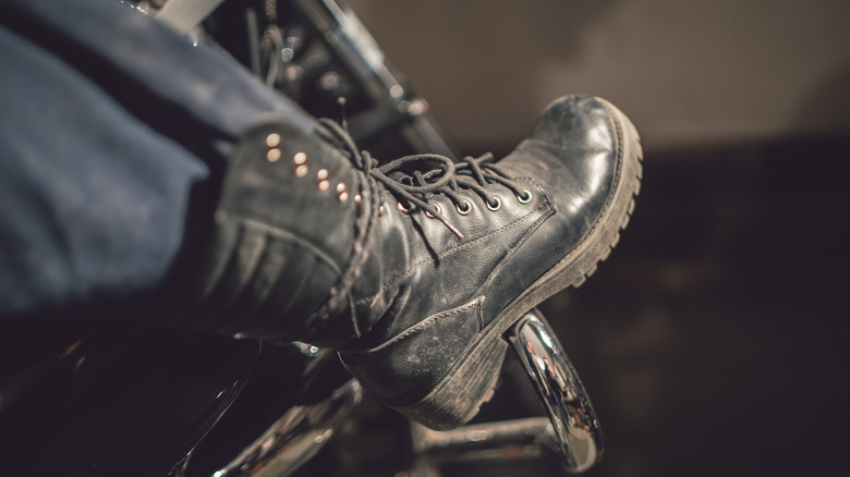 Motorcycle boot placed on side of a motorcycle