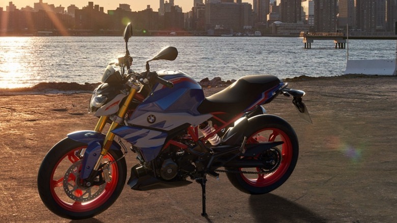 A blue BMW G 310 R with sunset background
