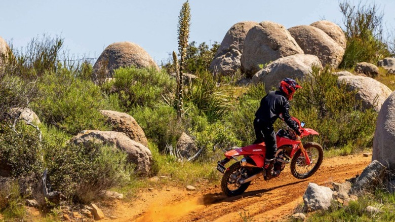 A man riding a Red Honda CRF 450L