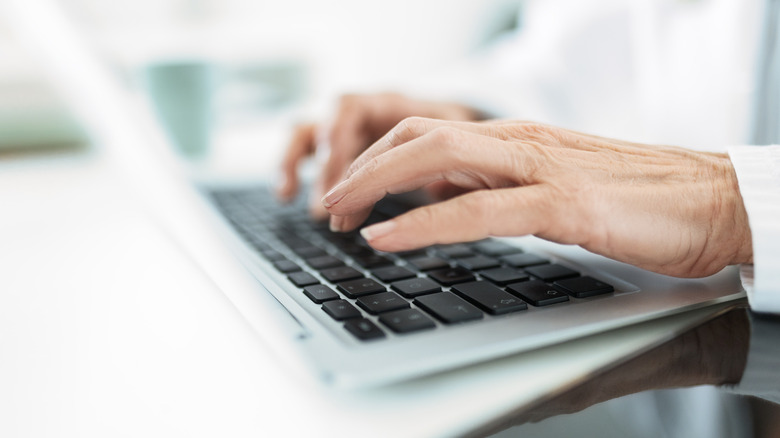 a person typing on a laptop
