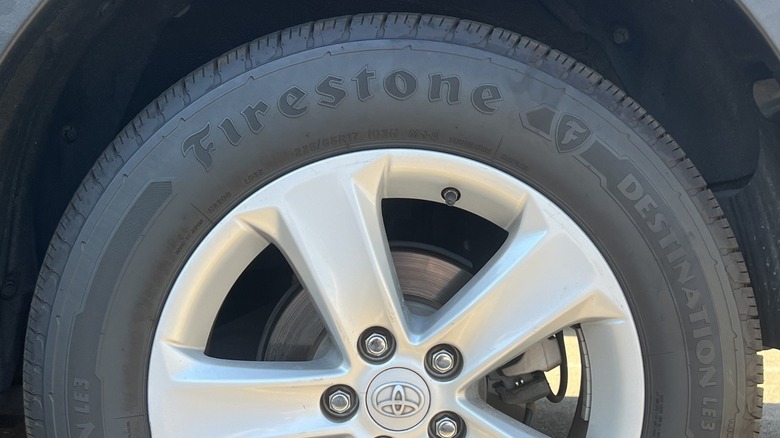 A Toyota wheel with a Firestone Destination LE3 tire