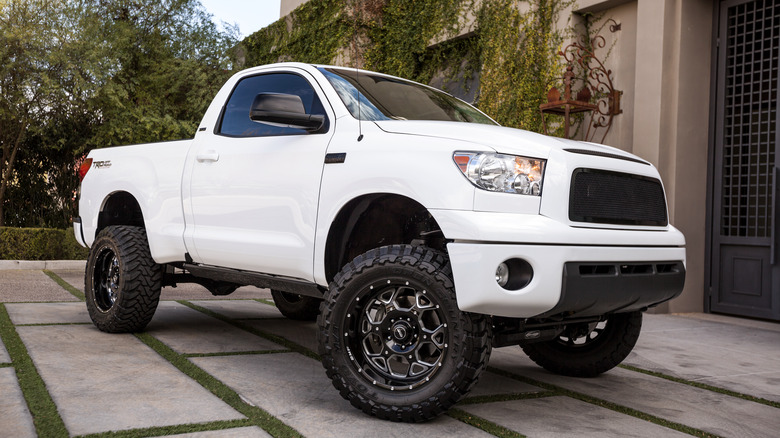 A second generation Toyota Tundra pickup truck seen here parked outside a fancy mansion front door