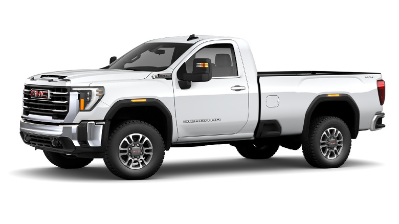 A white 2025 model year GMC 3500 HD pickup truck against a studio background