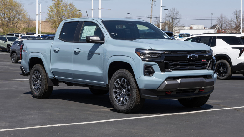 A 2025 light-blue Chevy Colorado Z71 in a bay outside a showroom