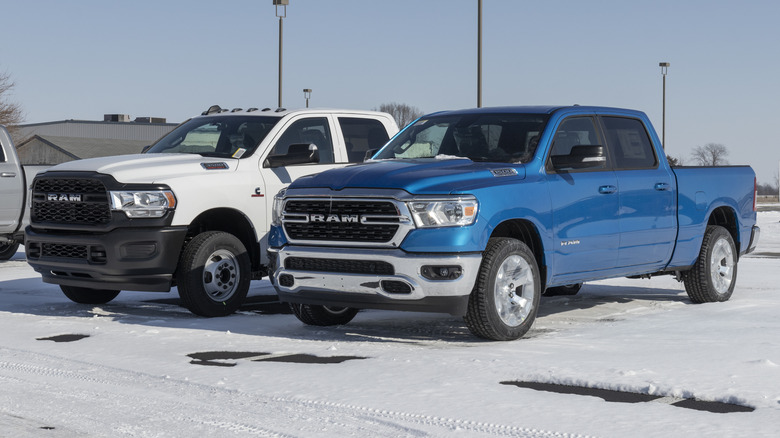 A blue Dodge RAM 3500 displayed at a Chrysler dealership in snow