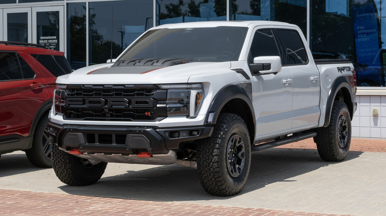 A Ford F150 Raptor 4x4 SuperCrew cab in grey outside a dealer