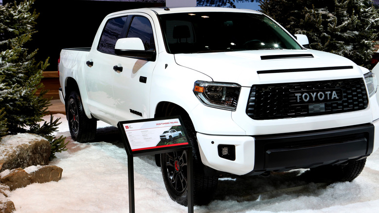 A Toyota TRD Pro Tundra finished in white on display at a car show indoors in 2020