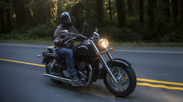 Motorcyclist in brown leather jacket on the highway
