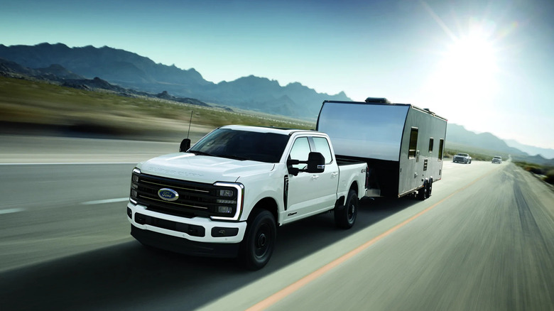 Ford F-350 towing a trailer front 3/4 view