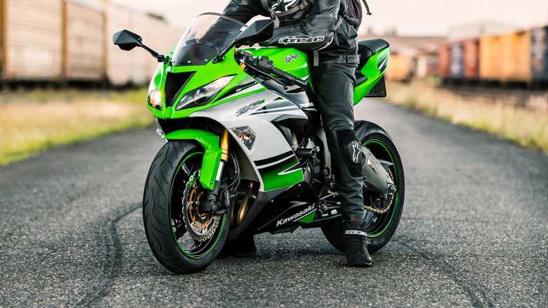 Kawasaki Ninja ZX-6R parked next to a train