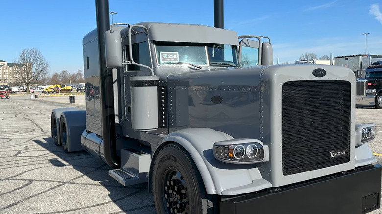 A custom matte gray Peterbilt semi truck with blacked-out trim.